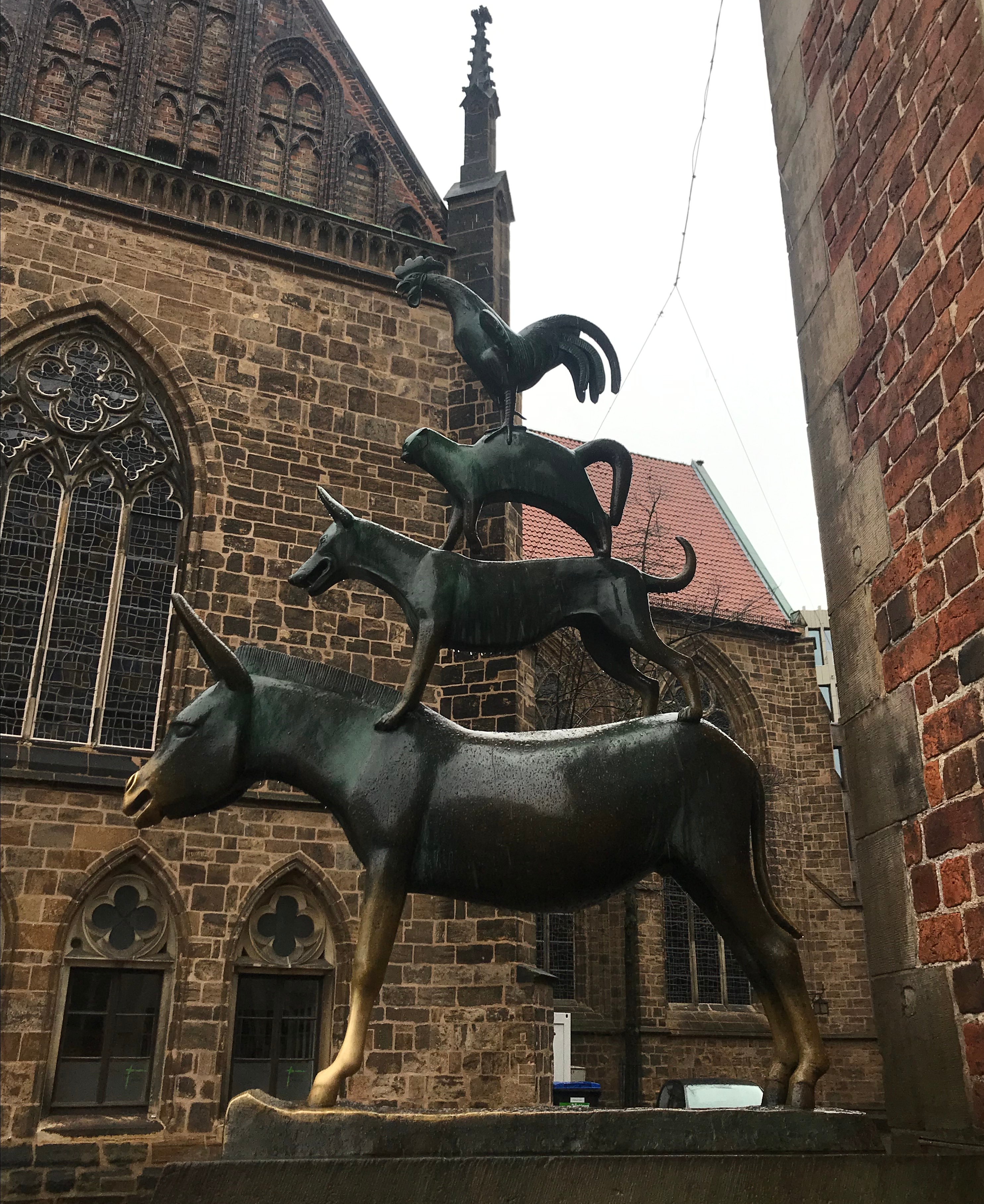 A statue showing a donkey, a dog, a cat and a cockerel standing on top of one another.